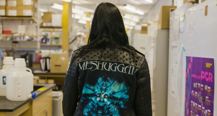 Women in metal jacket walking in lab